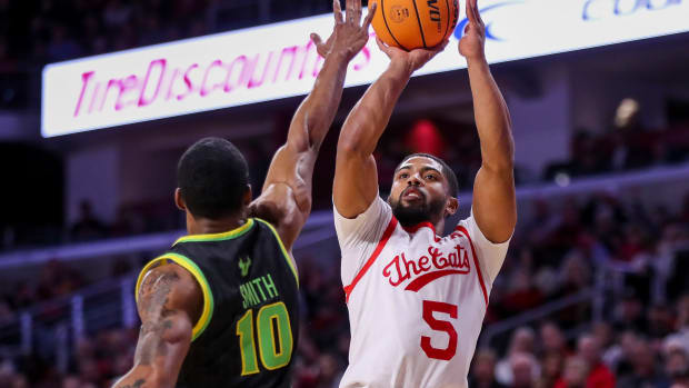 Feb 11, 2023; Cincinnati, Ohio, USA; Cincinnati Bearcats guard David DeJulius (5) shoots against South Florida Bulls guard Serrel Smith Jr. (10) in the first half at Fifth Third Arena. Mandatory Credit: Katie Stratman-USA TODAY Sports
